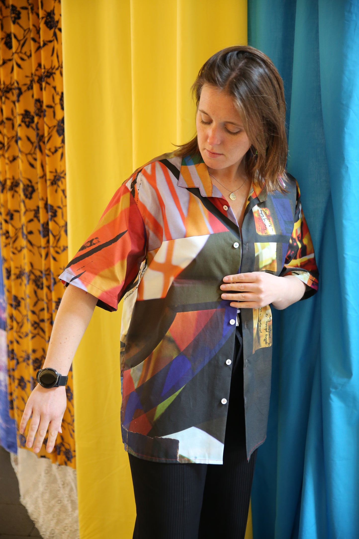 Person wearing a colorful patterned outfit on a blue and yellow background